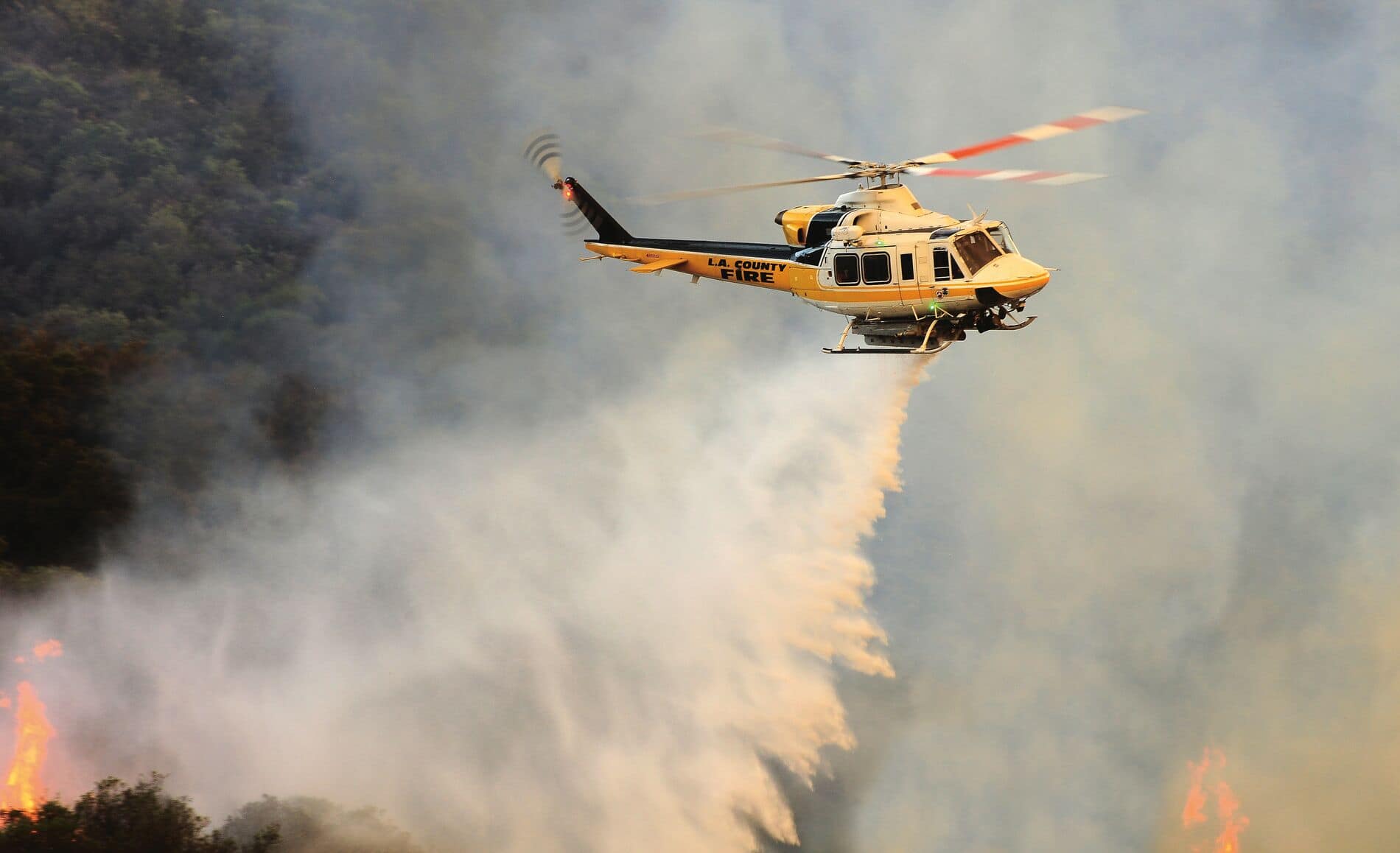 Bell 412 des pompiers du comté de LA versant de l'eau sur un feu